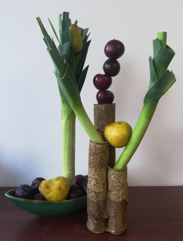 Fruit and vegetables arranged in vase